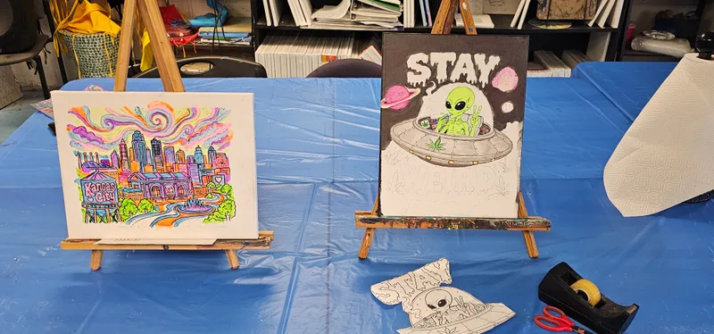 Finished canvases lined up on easels