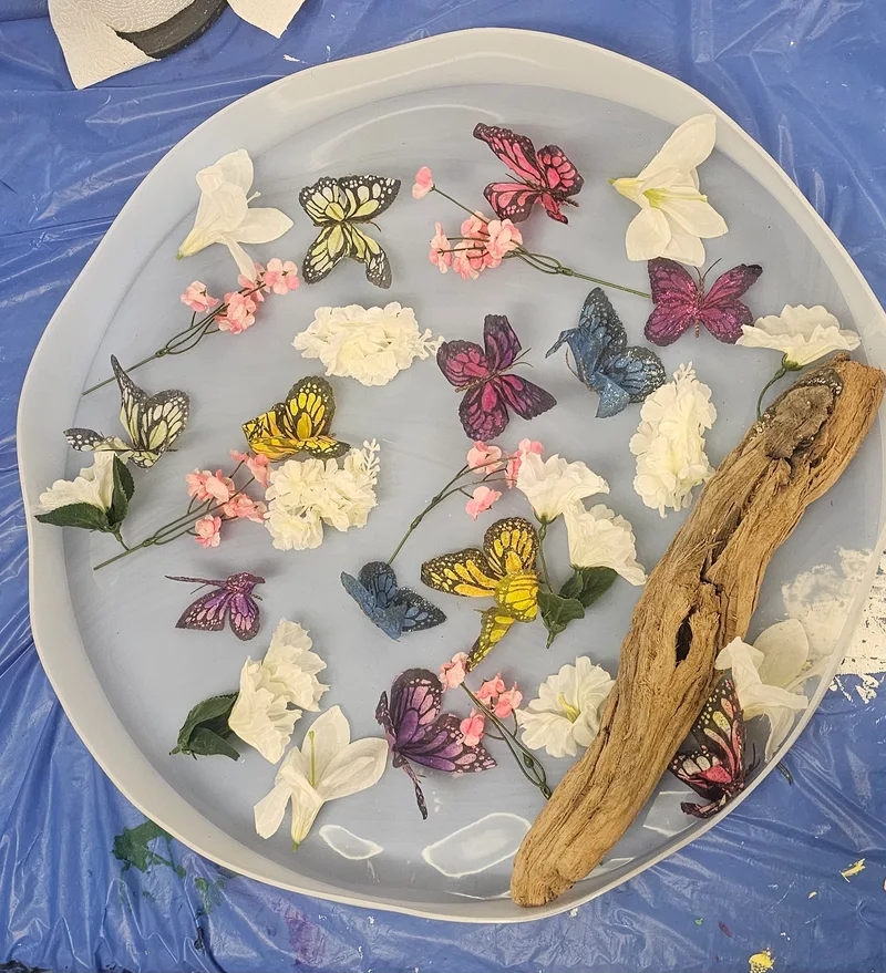 Cast butterflies and flowers laid out