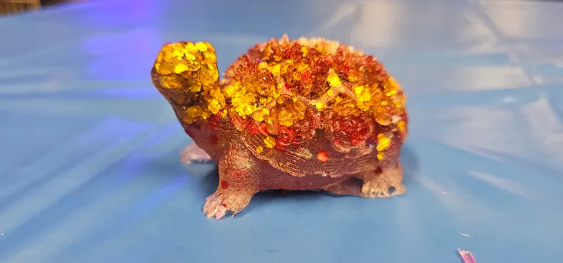 A resin turtle cast in amber and gold