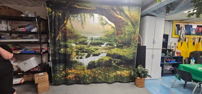 The studio interior with a painted mural wall