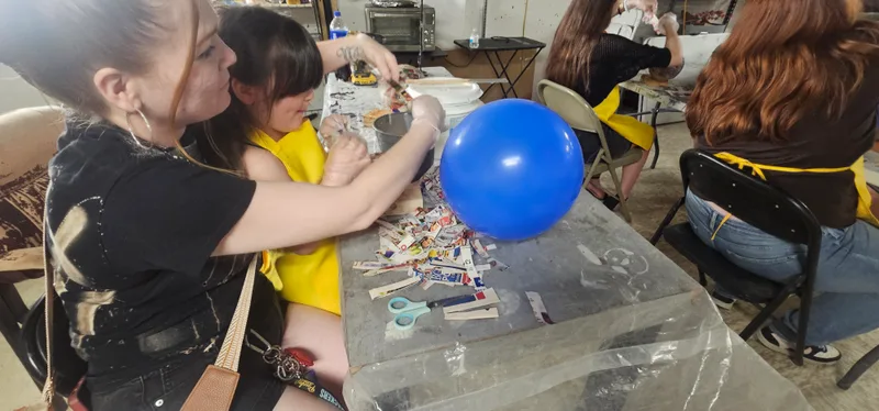 A member of staff working with a child on a project